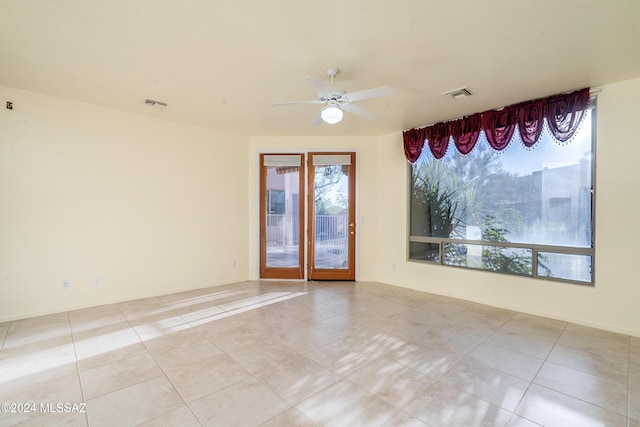 unfurnished room with plenty of natural light, ceiling fan, and light tile patterned floors