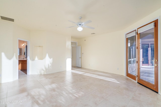 tiled spare room with ceiling fan