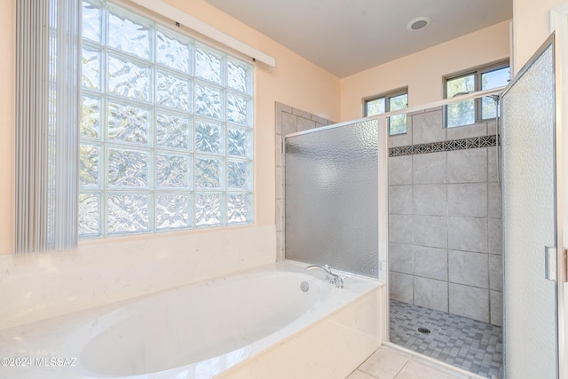 bathroom featuring plus walk in shower and tile patterned floors