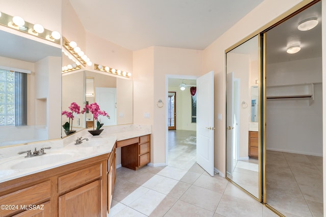 bathroom featuring tile patterned flooring, vanity, and ceiling fan