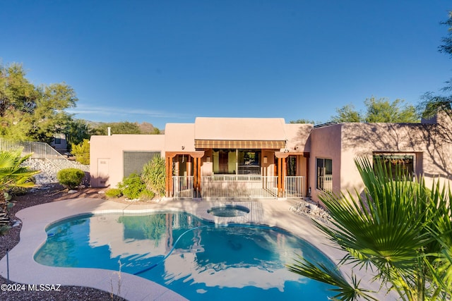 view of pool with an in ground hot tub and a patio