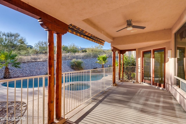 deck with ceiling fan, a patio area, and a fenced in pool