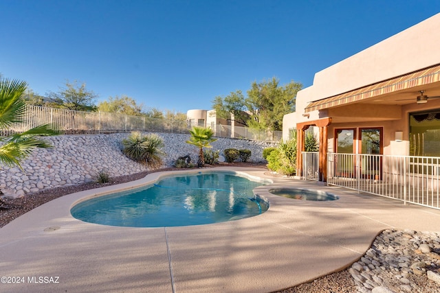 view of swimming pool with an in ground hot tub and a patio