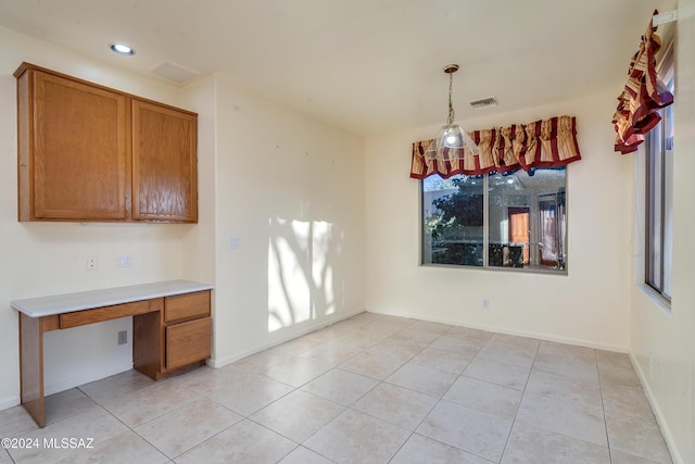 unfurnished dining area featuring light tile patterned floors