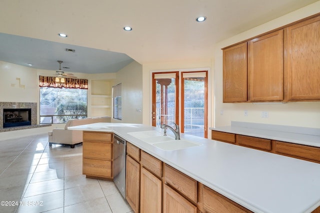 kitchen featuring ceiling fan, a center island, dishwasher, sink, and light tile patterned floors