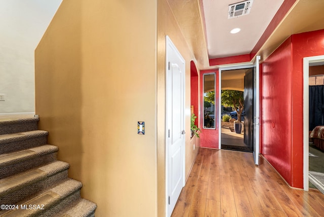 corridor with hardwood / wood-style flooring