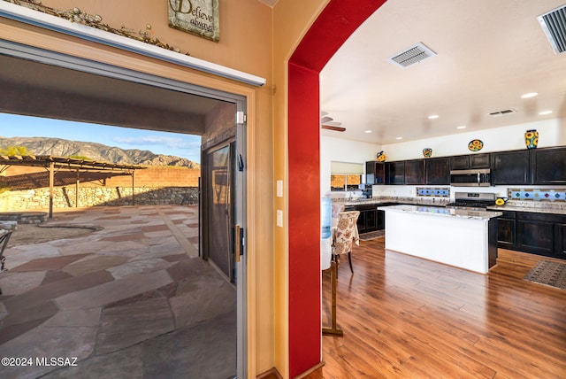 kitchen with a mountain view, range, and a kitchen island