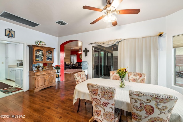 dining area with ceiling fan and dark hardwood / wood-style flooring