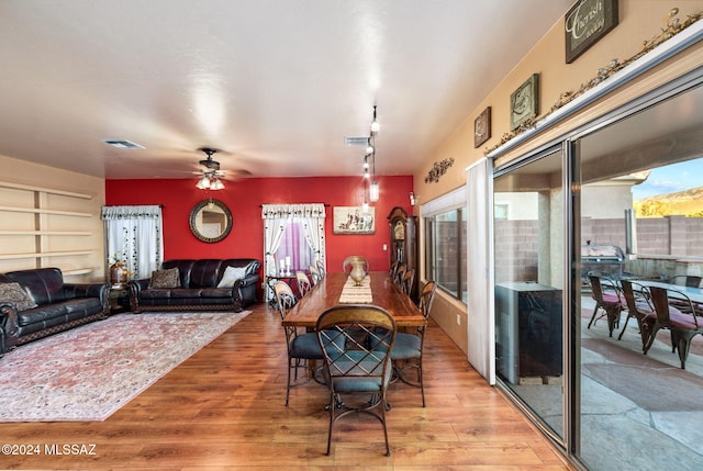 dining space featuring ceiling fan, a healthy amount of sunlight, and light hardwood / wood-style floors