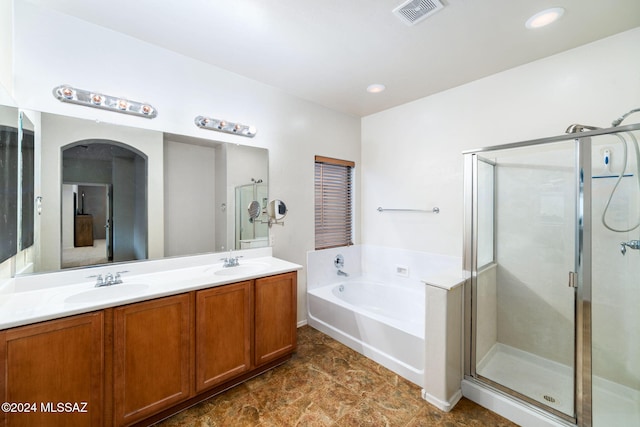 bathroom featuring vanity and separate shower and tub