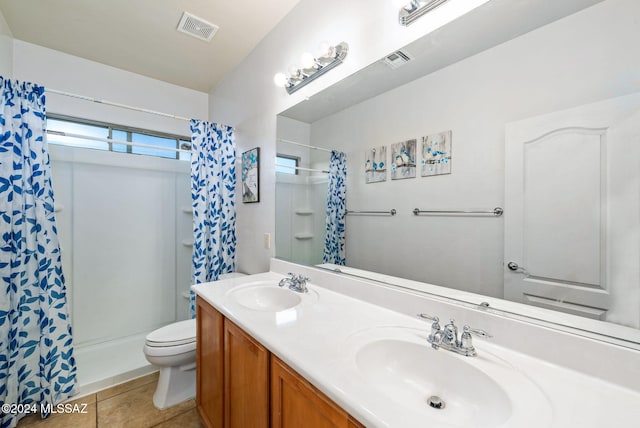 bathroom featuring toilet, vanity, a shower with shower curtain, and tile patterned floors