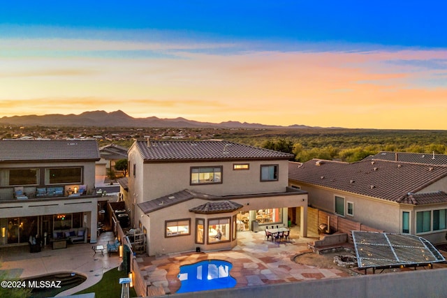 back house at dusk with a mountain view