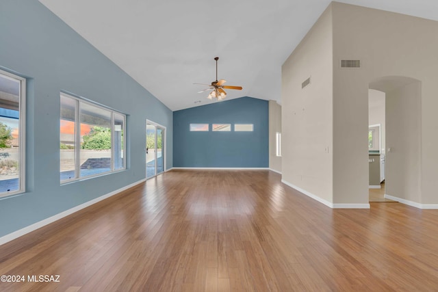 unfurnished living room featuring light hardwood / wood-style floors, high vaulted ceiling, and ceiling fan