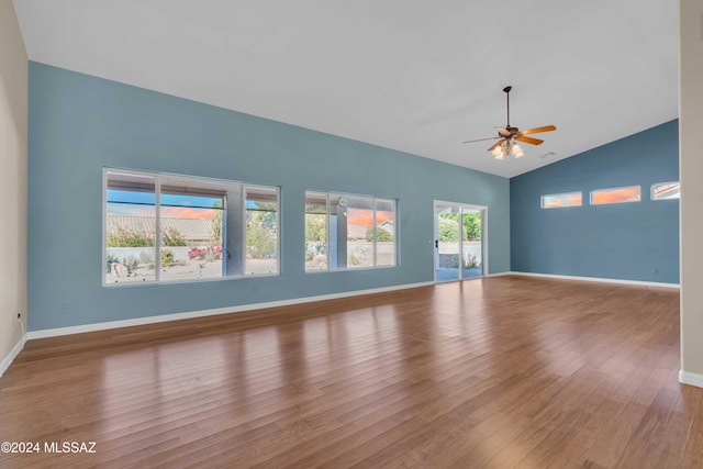 spare room with lofted ceiling, wood-type flooring, and ceiling fan