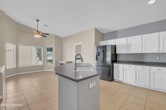 kitchen featuring sink, a kitchen island with sink, stainless steel refrigerator with ice dispenser, and light tile patterned floors