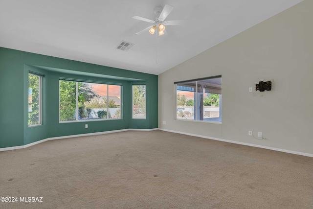 carpeted empty room featuring vaulted ceiling and ceiling fan