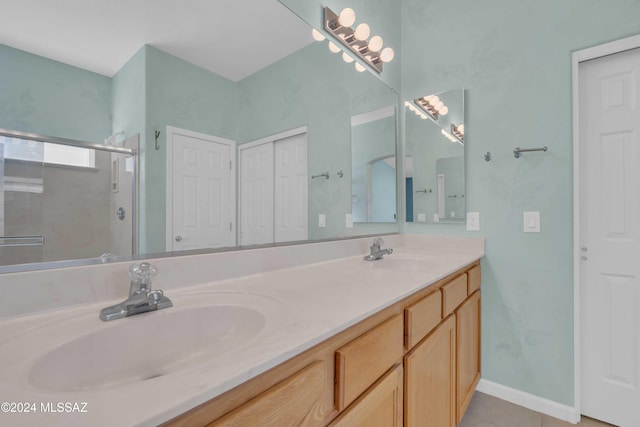 bathroom with vanity and a shower with shower door