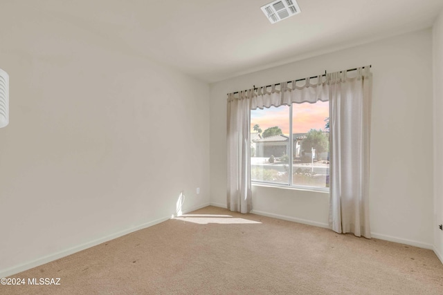 unfurnished room featuring light colored carpet