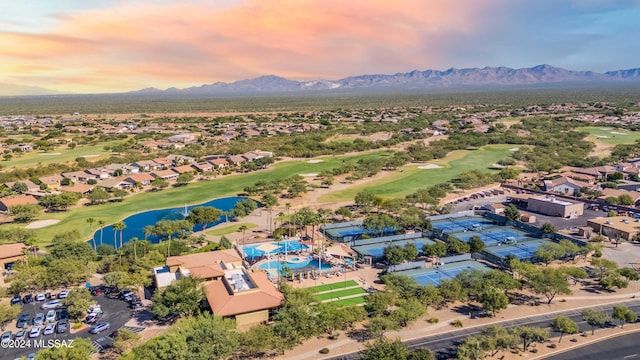 aerial view at dusk featuring a water and mountain view