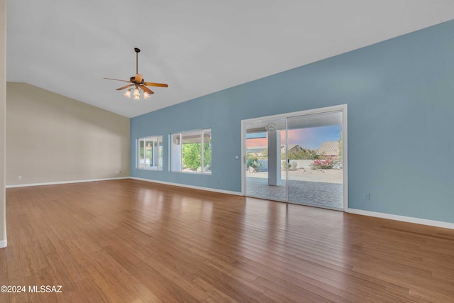 empty room featuring ceiling fan, lofted ceiling, and light wood-type flooring