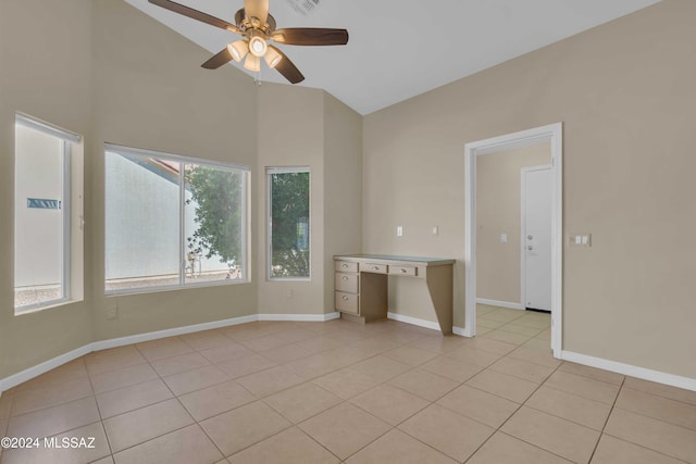 empty room with ceiling fan, high vaulted ceiling, and light tile patterned flooring