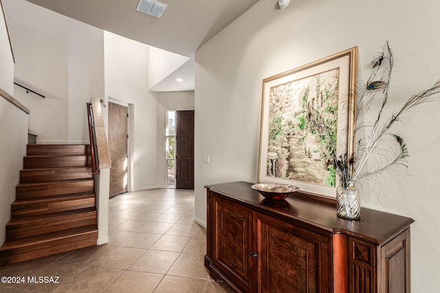 tiled entryway featuring vaulted ceiling