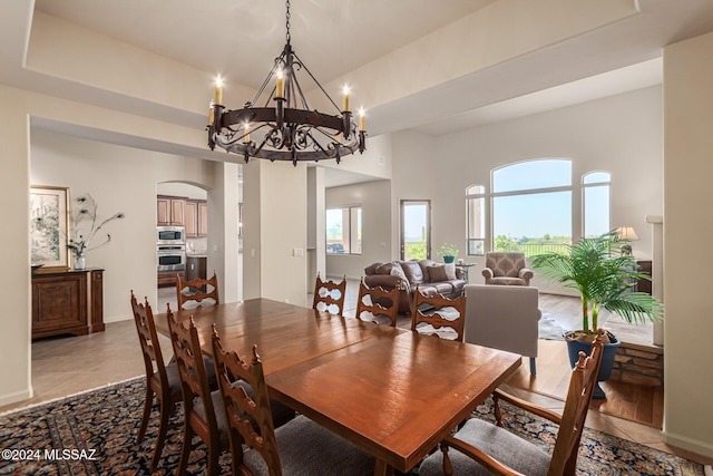 dining area with an inviting chandelier and light wood-type flooring