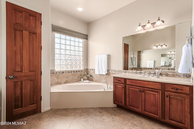 bathroom with vanity, tile patterned floors, and a washtub