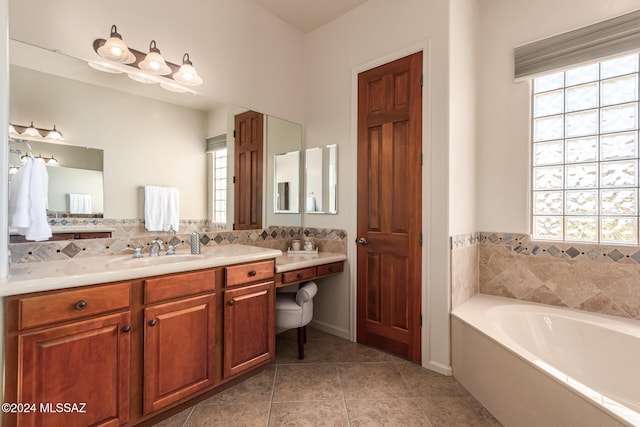 bathroom with vanity, a bathtub, and tile patterned flooring