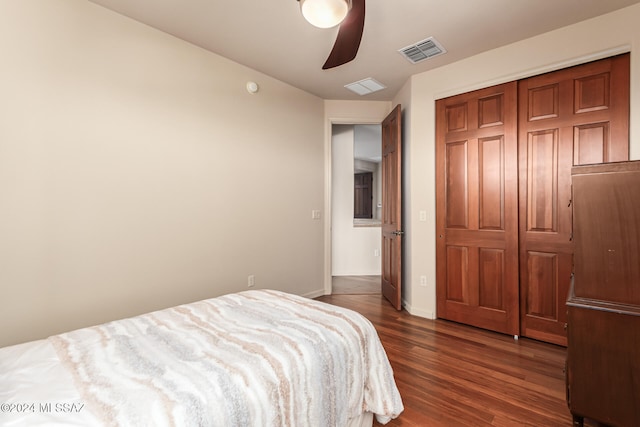 bedroom featuring a closet, dark wood-type flooring, and ceiling fan