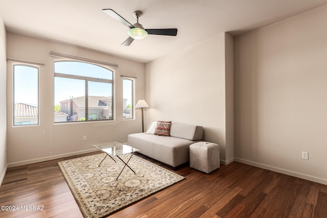 sitting room with ceiling fan and dark hardwood / wood-style flooring