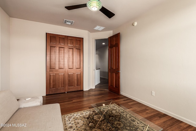 bedroom featuring a closet, dark wood-type flooring, and ceiling fan