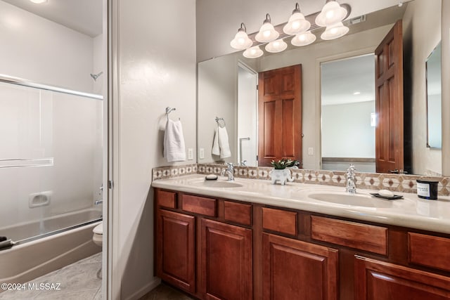 full bathroom featuring vanity, combined bath / shower with glass door, toilet, and tile patterned flooring