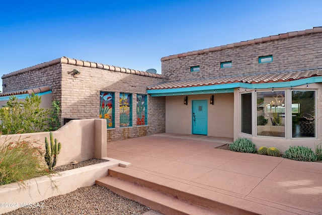 back of property featuring a patio area