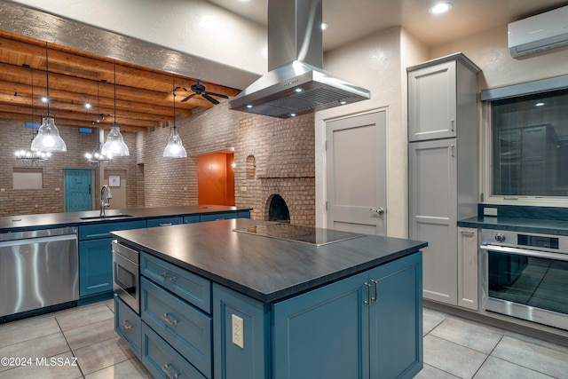 kitchen with island exhaust hood, beamed ceiling, stainless steel appliances, brick wall, and blue cabinets