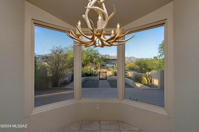 unfurnished dining area featuring tile patterned flooring, lofted ceiling, and a wealth of natural light