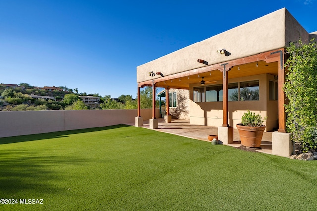 view of yard with a patio area and ceiling fan