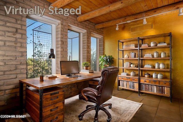 tiled home office featuring wood ceiling, beamed ceiling, and brick wall