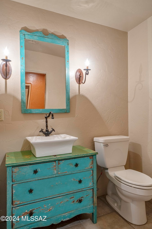 bathroom with vanity, toilet, and tile patterned floors