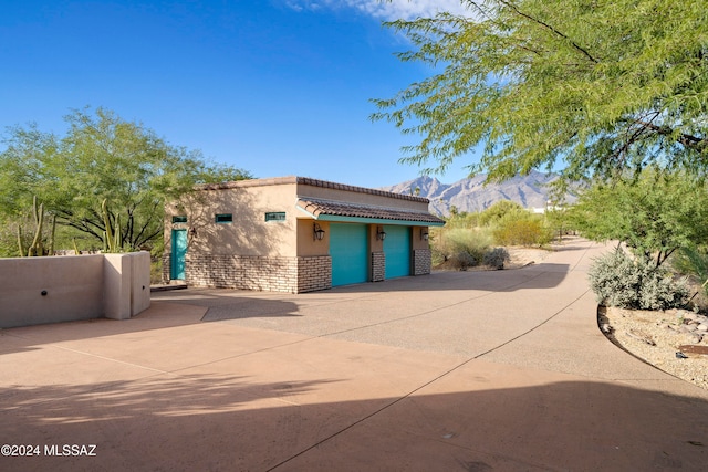 view of front facade featuring a mountain view and a garage