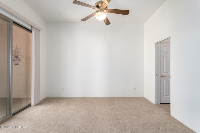 spare room featuring ceiling fan and light carpet