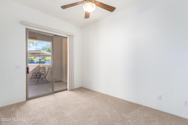 carpeted empty room featuring ceiling fan