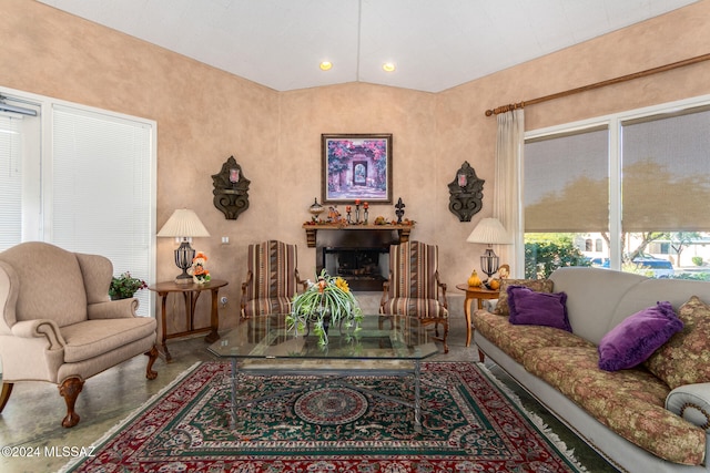 living room featuring concrete flooring and vaulted ceiling