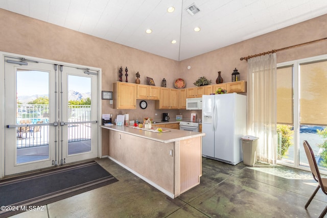 kitchen featuring light brown cabinetry, kitchen peninsula, white appliances, and french doors