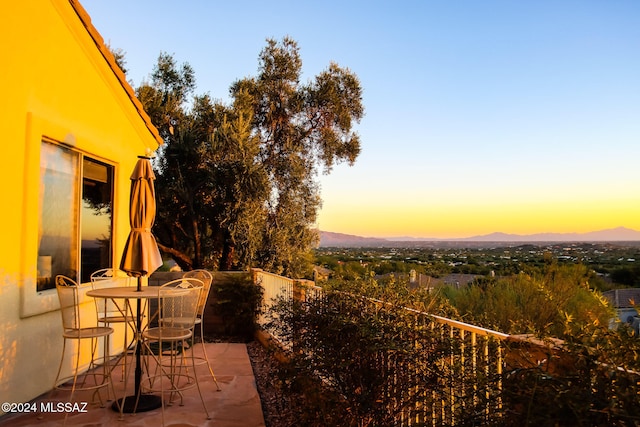 patio terrace at dusk with a mountain view