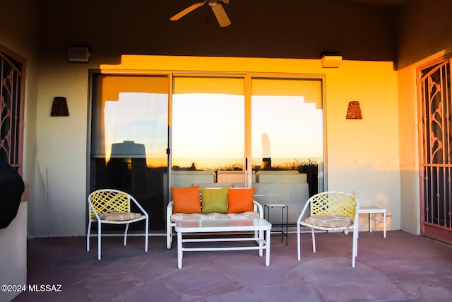 patio terrace at dusk featuring ceiling fan