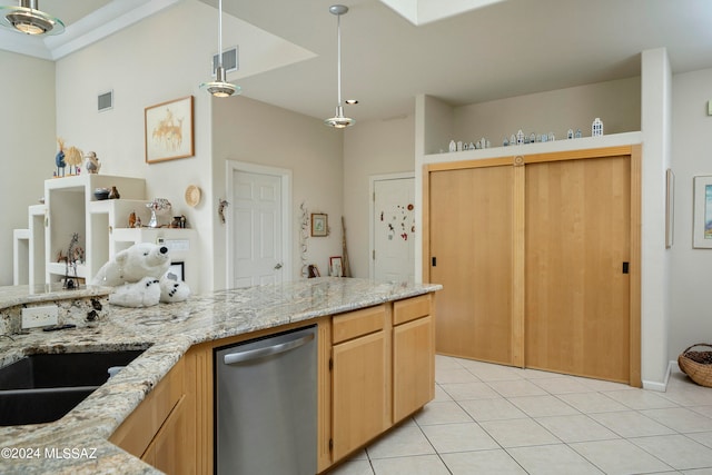 kitchen with light brown cabinetry, light stone counters, light tile patterned floors, decorative light fixtures, and dishwasher