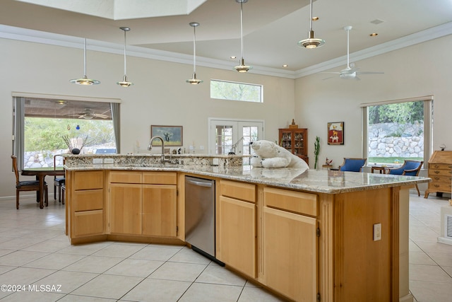 kitchen with ceiling fan, sink, light brown cabinets, a high ceiling, and light tile patterned floors