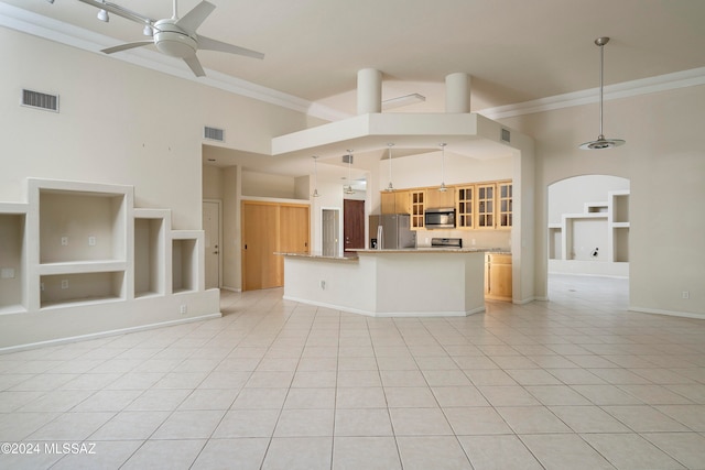 kitchen featuring crown molding, high vaulted ceiling, hanging light fixtures, and appliances with stainless steel finishes