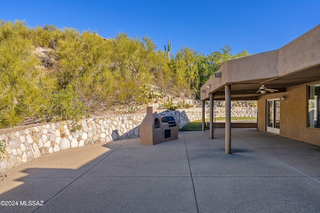 view of patio with area for grilling and ceiling fan